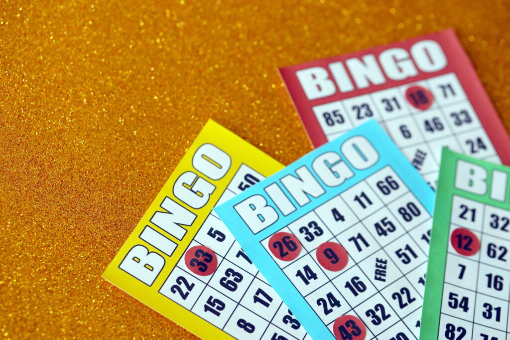 Many colorful bingo boards or playing cards for winning chips