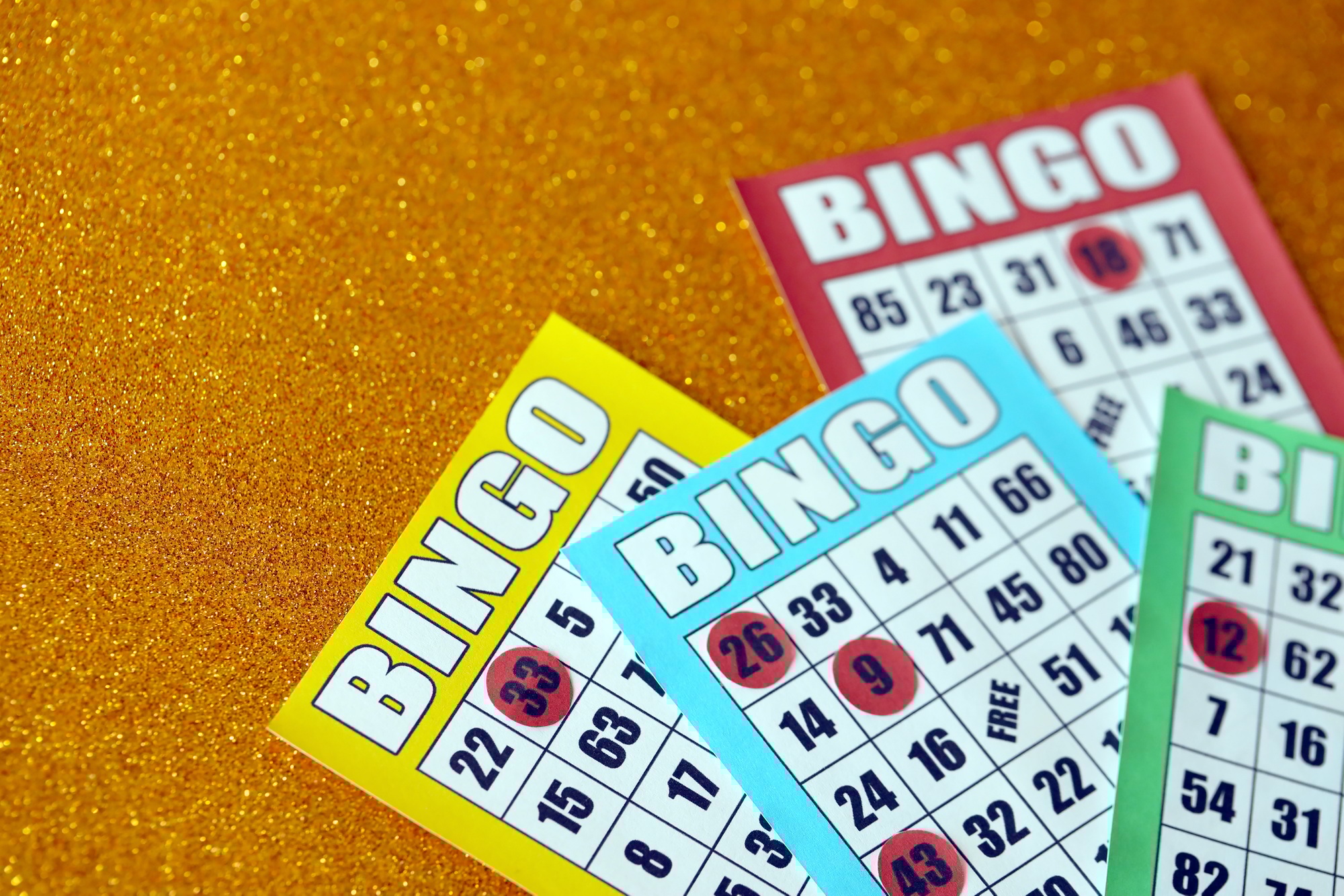 Many colorful bingo boards or playing cards for winning chips